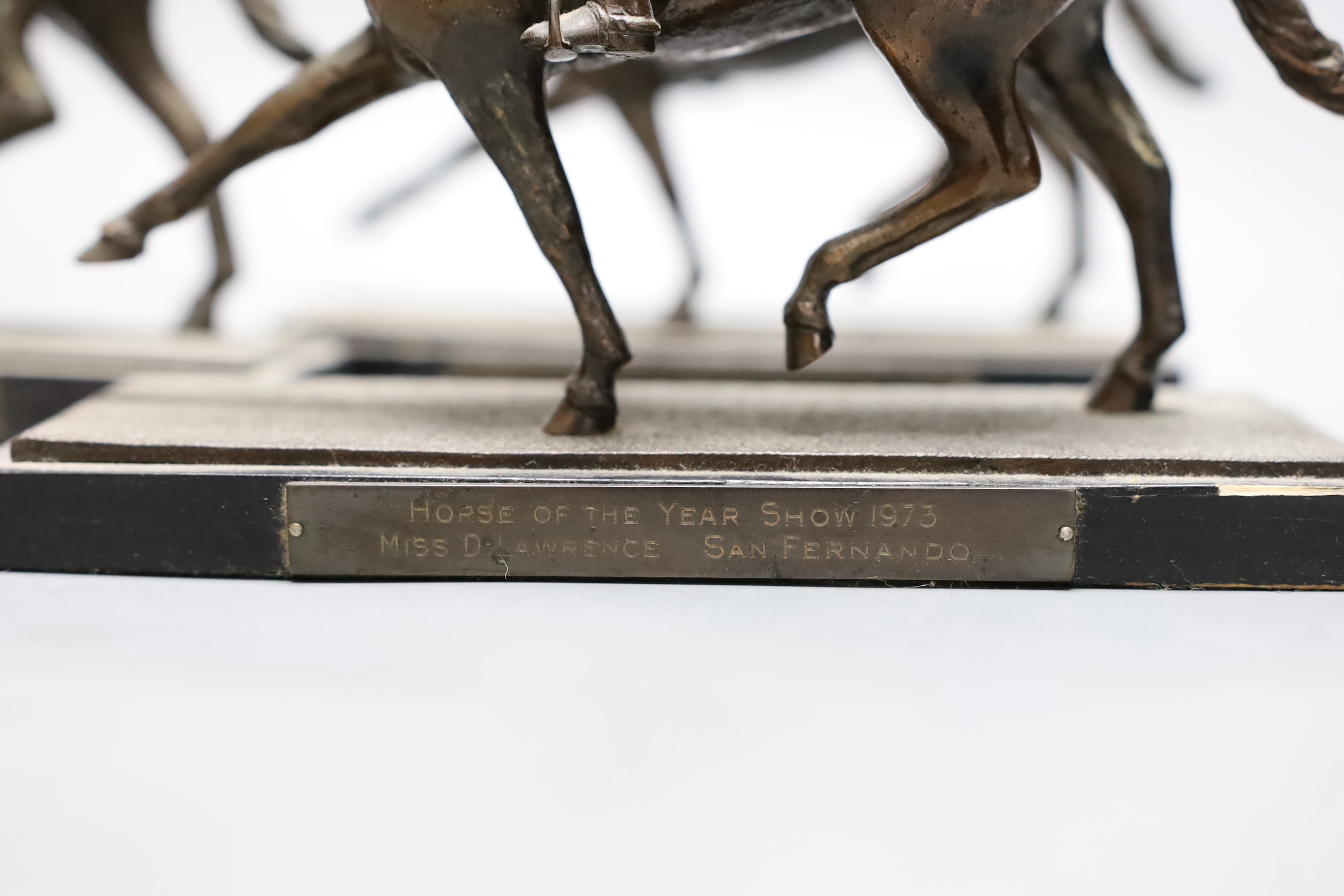 Five bronze spelter models of dressage horse and rider awarded to Domini Lawrence c.1970s, 15cm tall